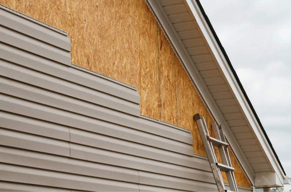A picture of the side of a house with siding being installed in Asheville, NC.